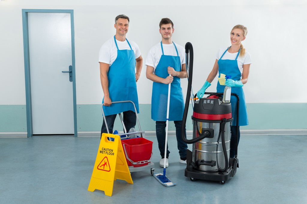 Portrait Of Happy Three Workers With Cleaning Equipments