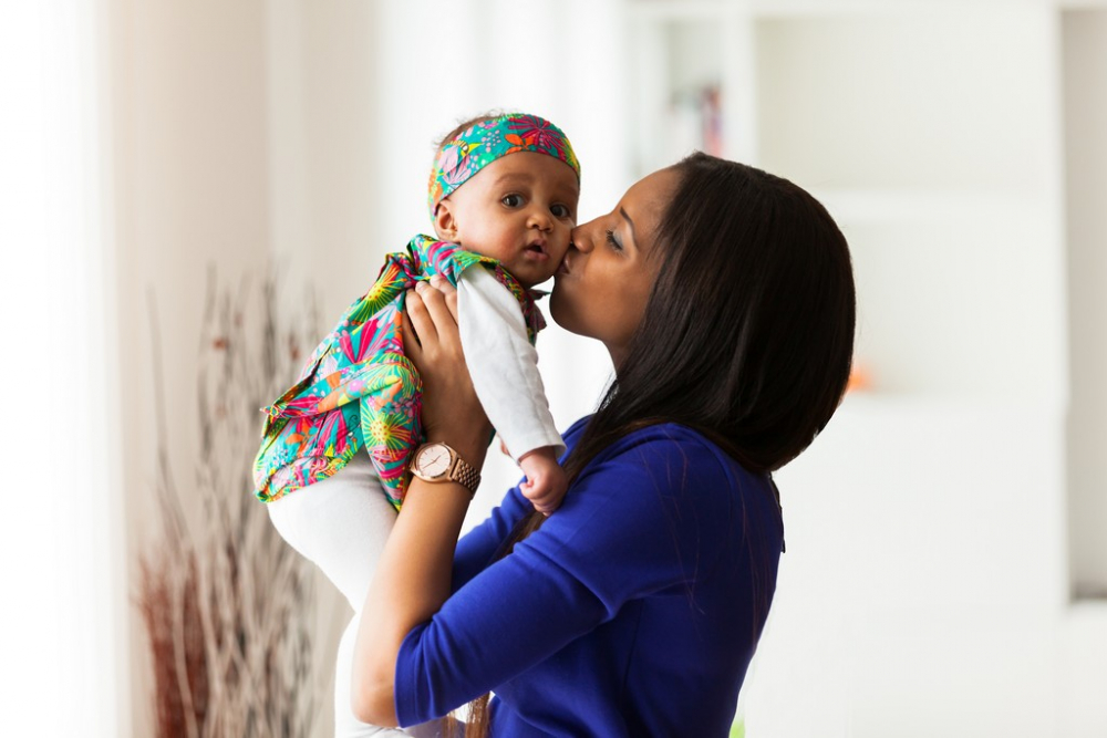 woman carrying an infant