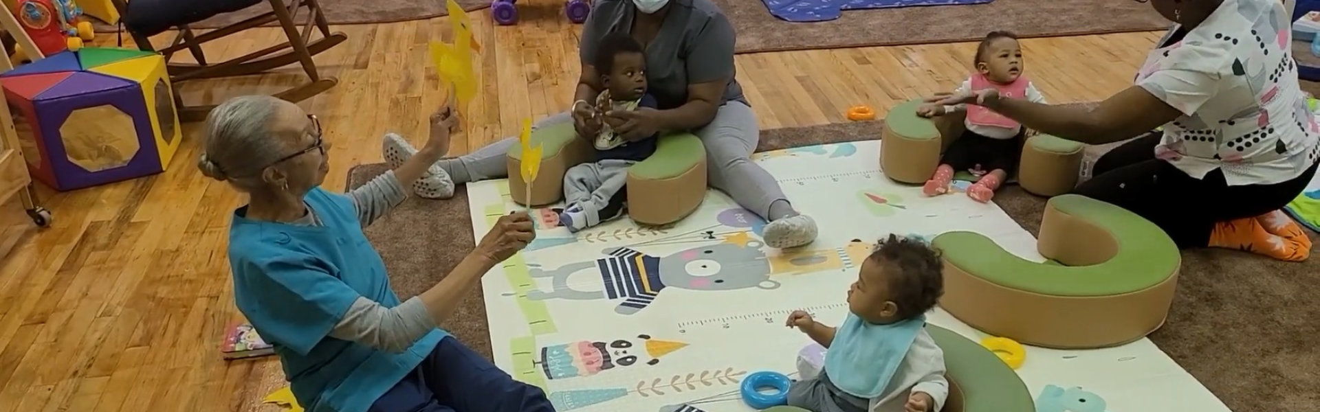 teacher with all of the children around her at the table